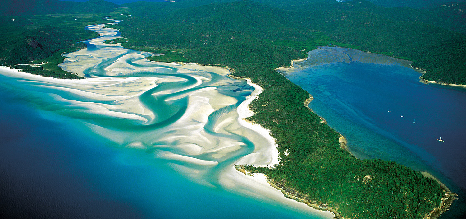 The Whitsunday Islands yacht charter aerial view shows the vibrant blues and greens of the area